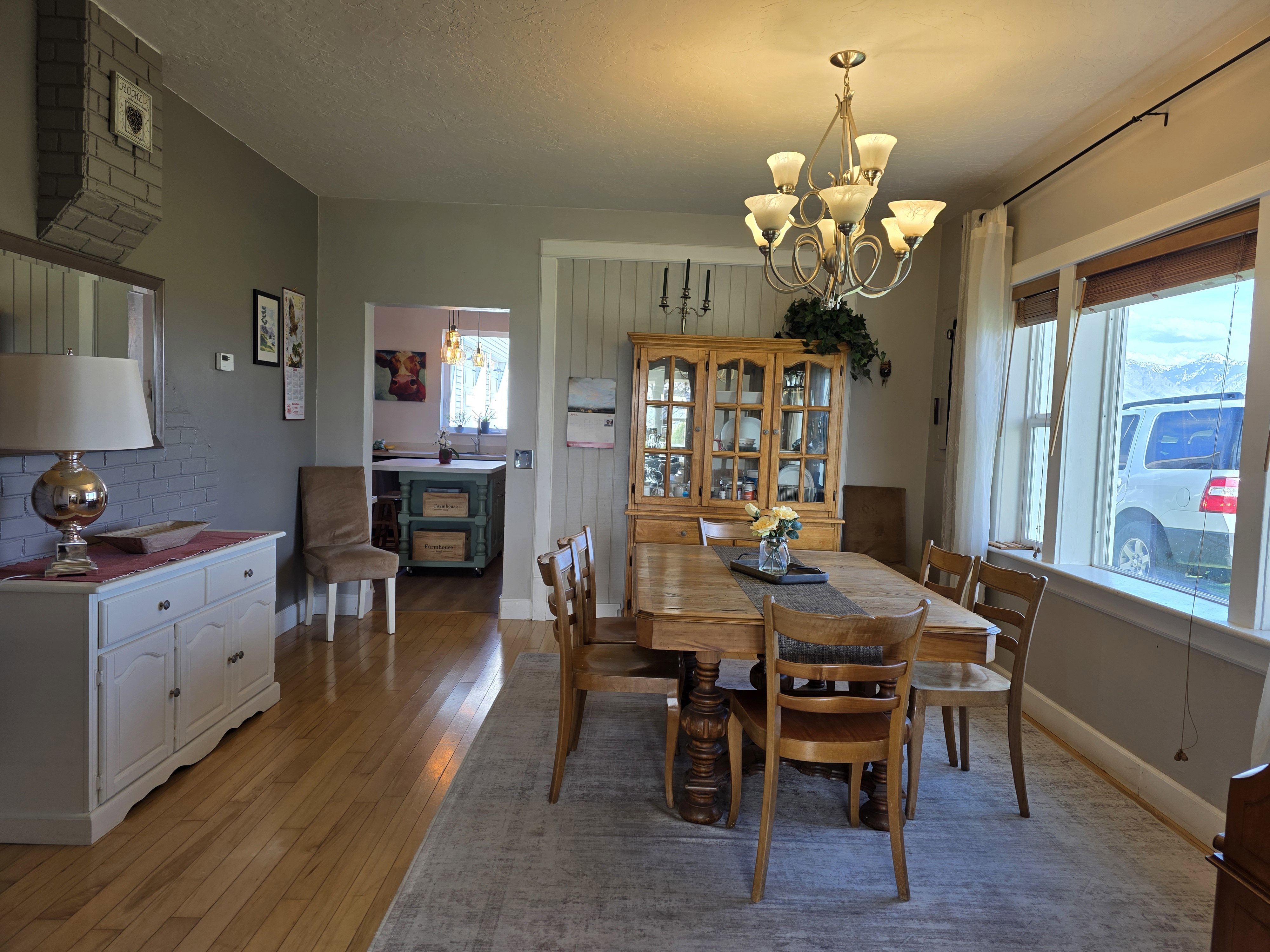 Dining area with suspended lighting, light wood-style flooring, and a textured ceiling