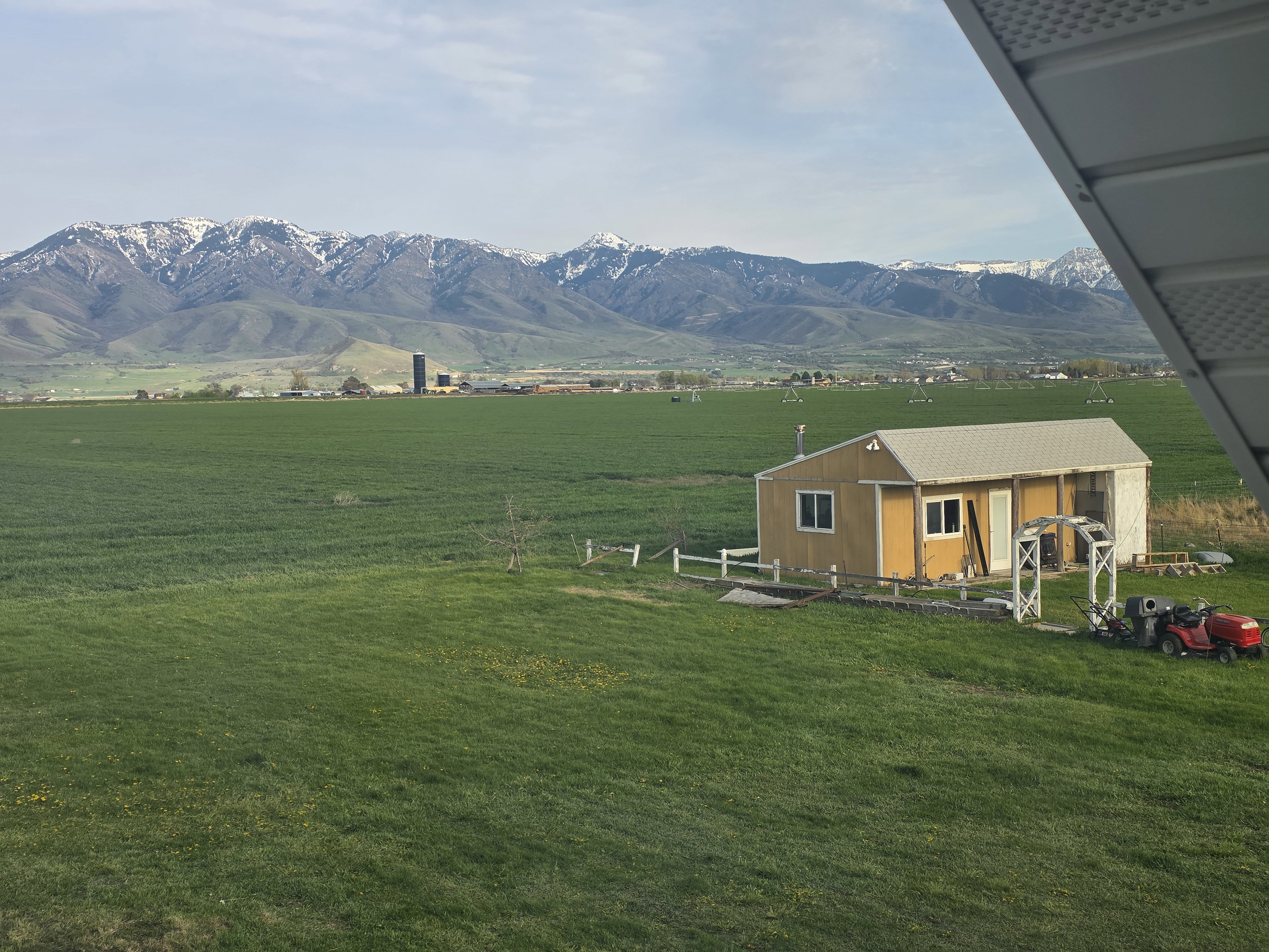 View of mountain backdrop featuring rural landscape and agricultural land