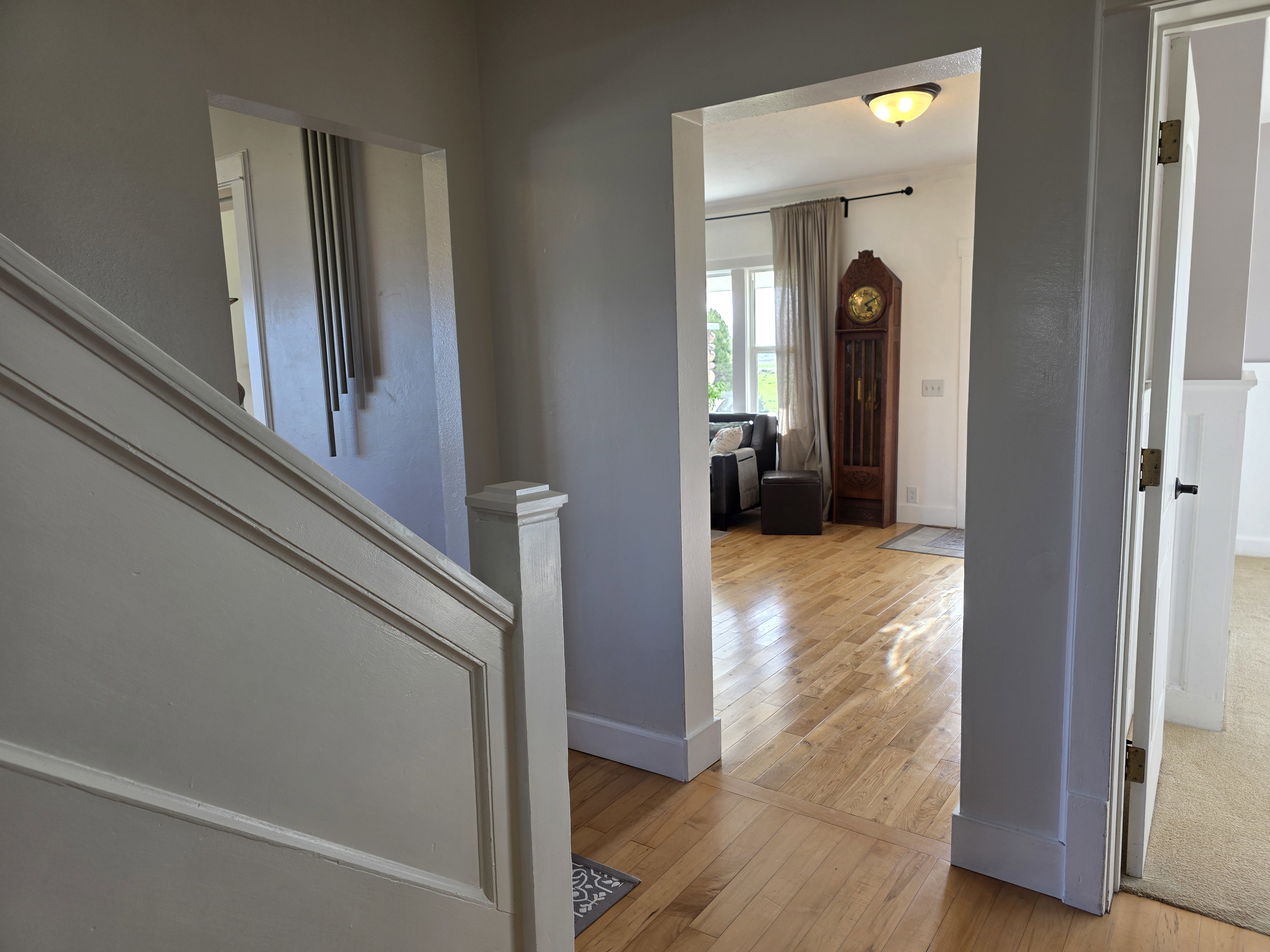 Corridor with light wood-style floors and baseboards