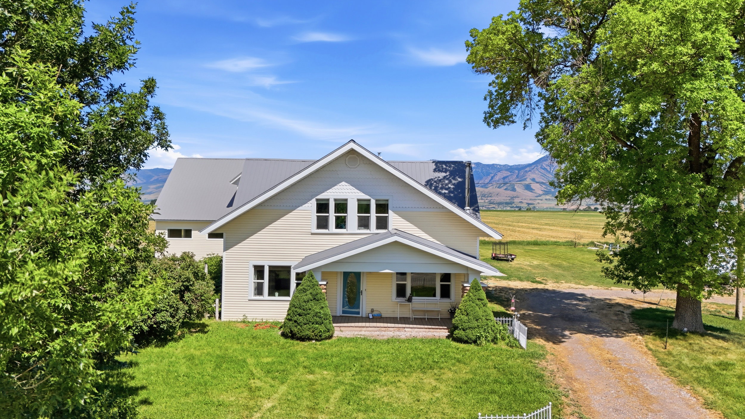 Cream-colored exterior with a gray roof and white trim