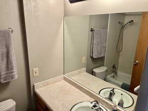 Bathroom with vanity and bathing tub / shower combination