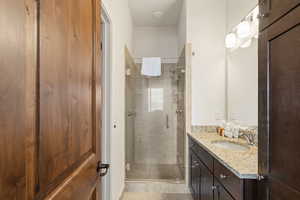 Bathroom featuring vanity and a shower stall