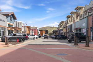 View of street with sidewalks, a mountain view, and curbs