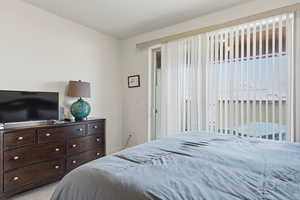 Bedroom with access to exterior and carpet