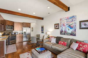 Living area with recessed lighting, dark wood-type flooring, and beam ceiling
