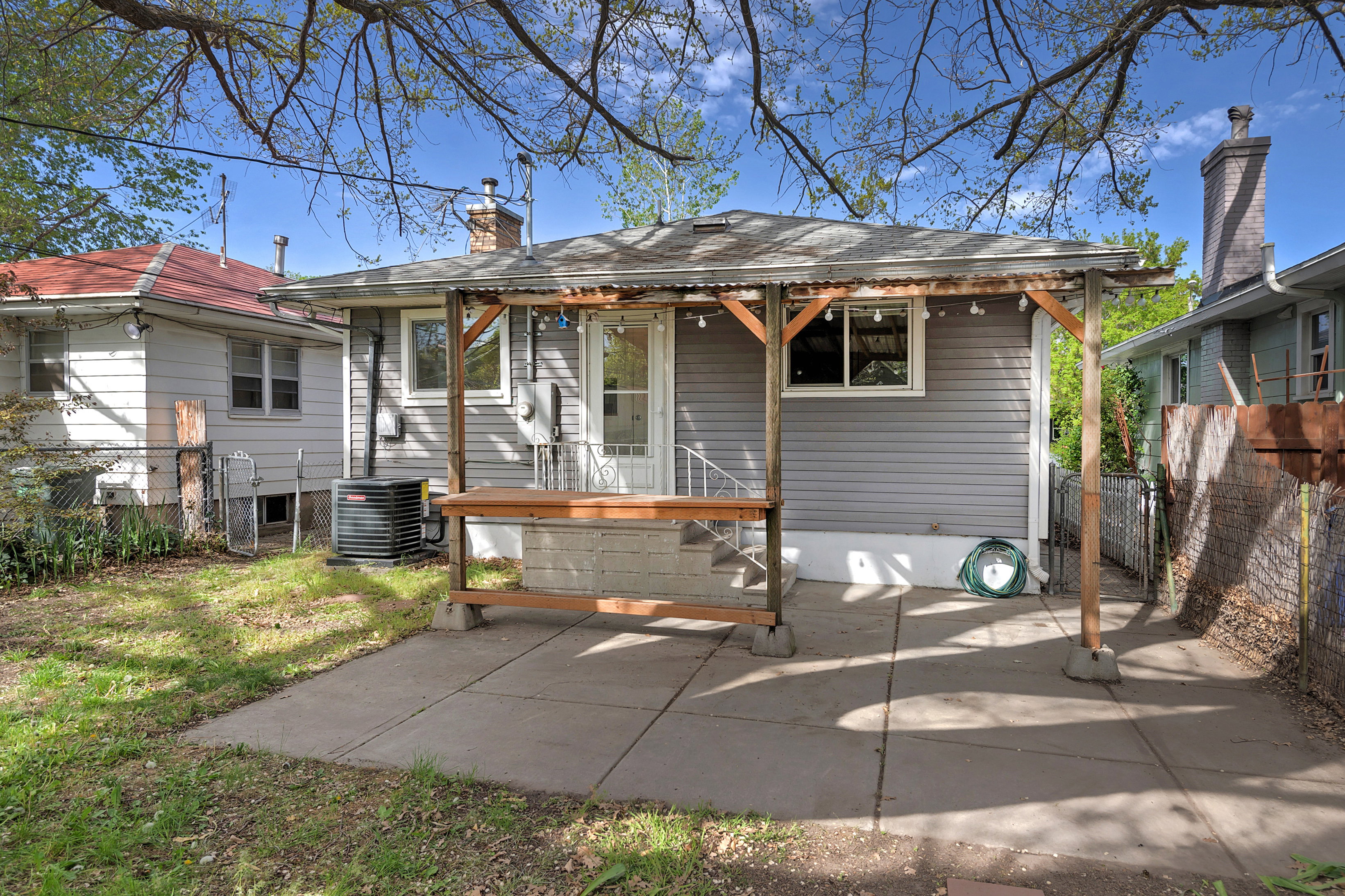 Rear view of property with a chimney and a patio area
