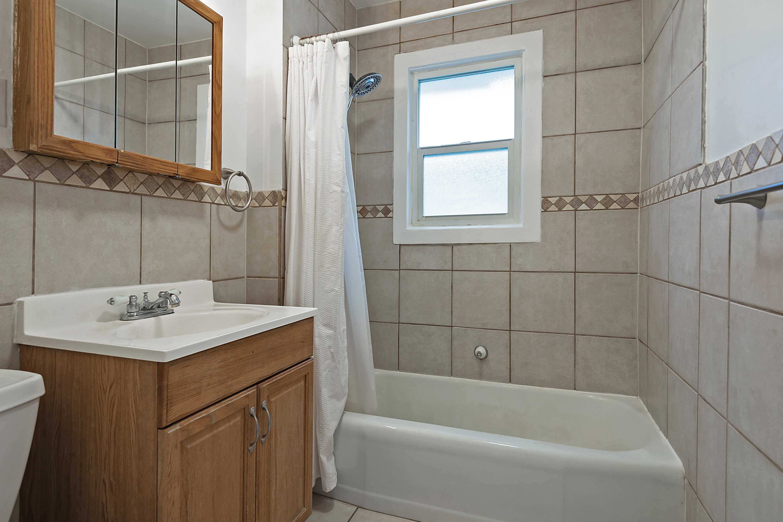 Full bathroom with vanity and shower / bathtub combination with curtain