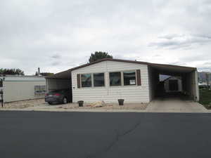 View of front of home featuring two carports.