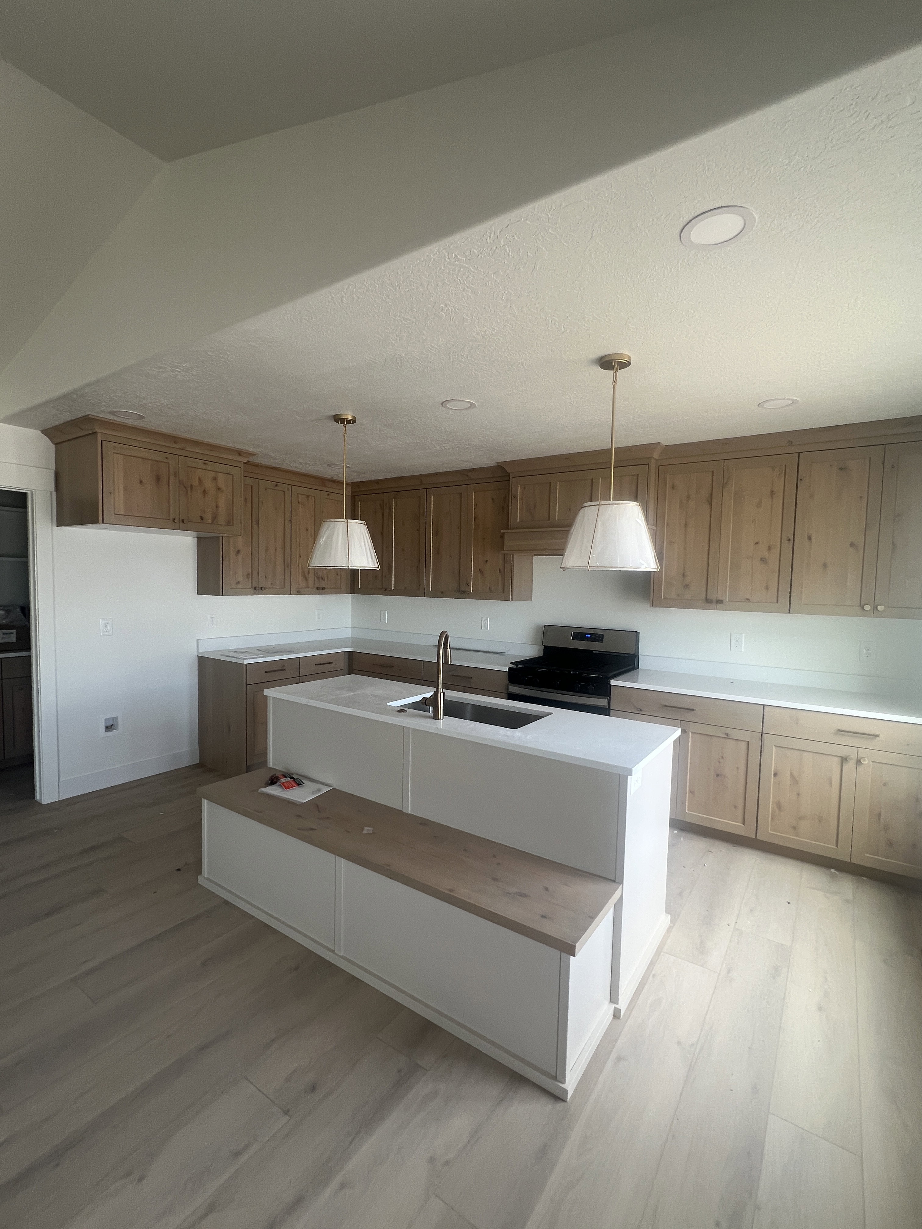 Kitchen featuring light wood-finish flooring and extensive cabinetry