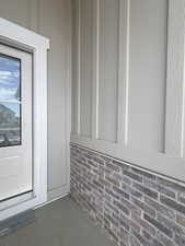 Exterior facade showcasing board and batten siding over a brick foundation