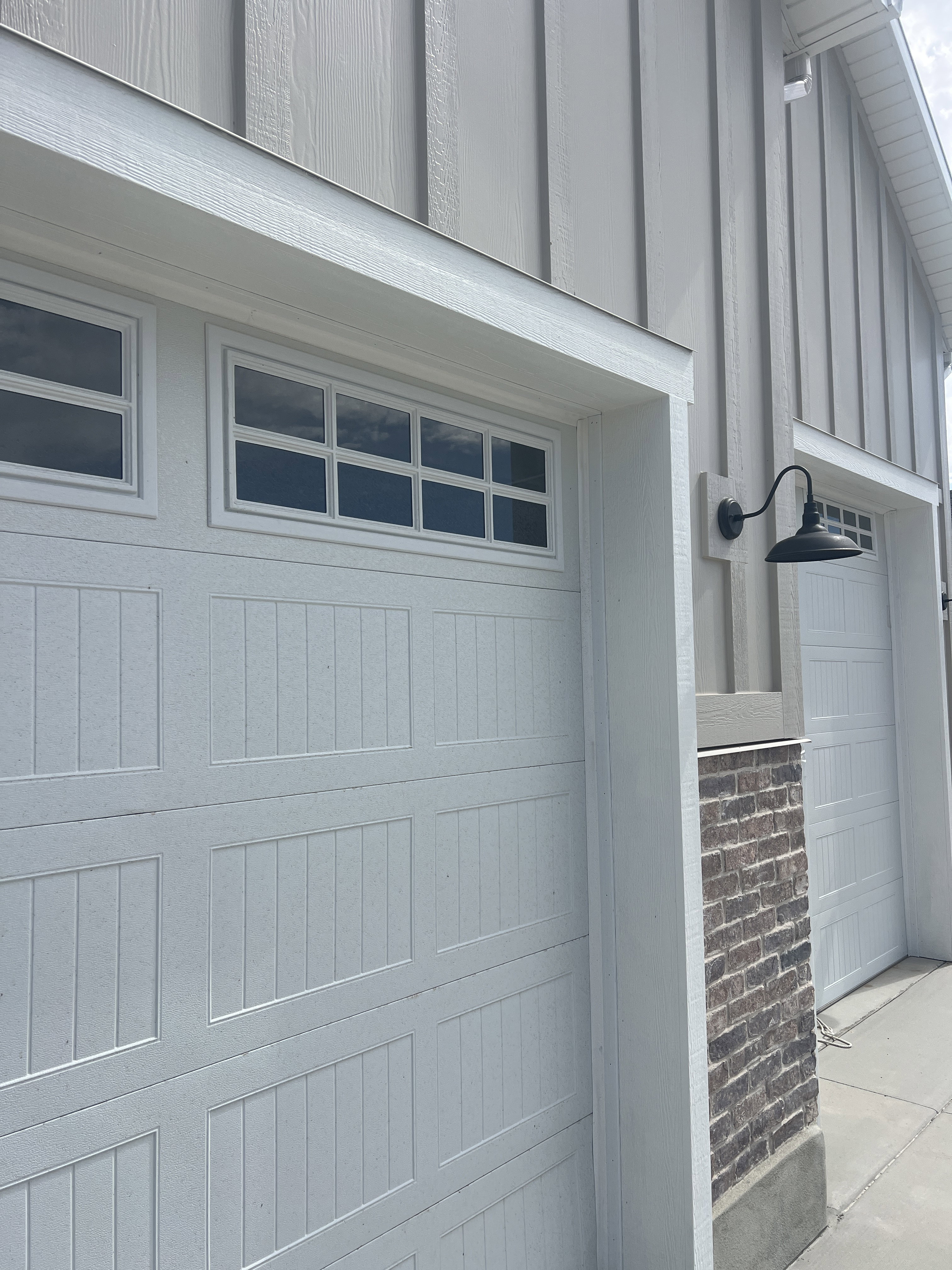 White paneled garage doors with upper window inserts