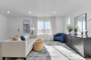Living room featuring light wood finished floors and recessed lighting
