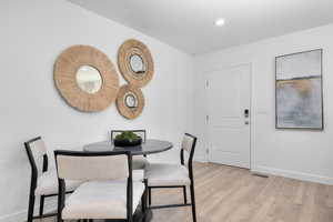 Dining area featuring light wood-style flooring and recessed lighting