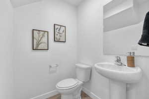Bathroom featuring baseboards and wood finished floors