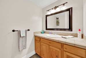 Bathroom featuring vanity and baseboards