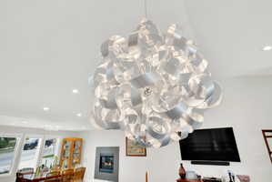 Detailed view of recessed lighting and a glass covered fireplace