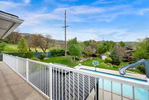 Balcony featuring view of pool area