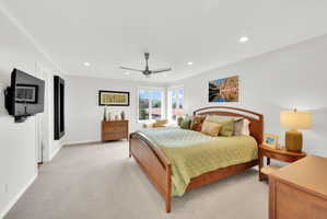 Master Bedroom with crown molding, recessed lighting, light colored carpet, and ceiling fan
