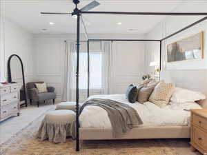 Bedroom featuring a decorative wall, ceiling fan, carpet flooring, and recessed lighting