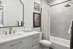 Full bathroom featuring vanity and shower / bath combination with curtain