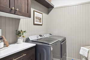 Laundry area featuring cabinet space and separate washer and dryer