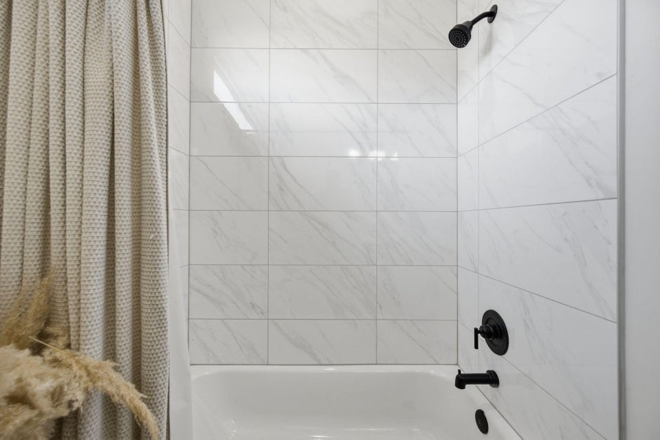 Full bathroom with shower / tub combo with curtain