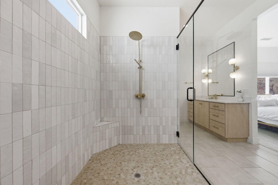 Ensuite bathroom with plenty of natural light, a stall shower, and vanity