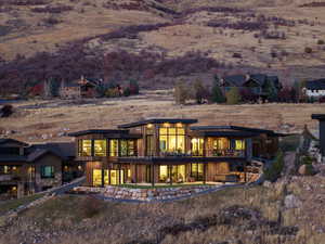 Rear view of house with a patio and a balcony