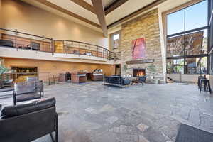 View of patio featuring a fireplace and an outdoor kitchen and area to lounge
