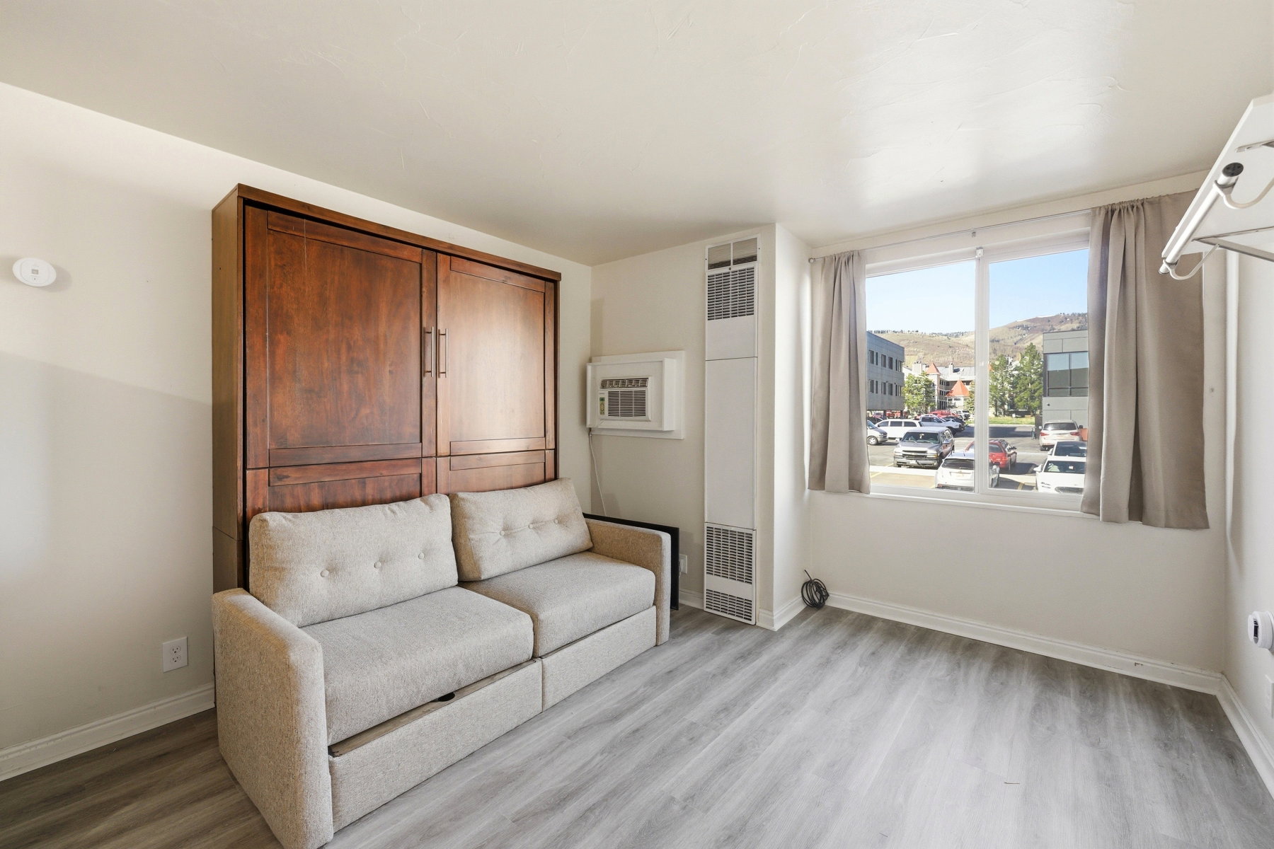 Unfurnished room featuring a heating unit and light wood-style flooring
