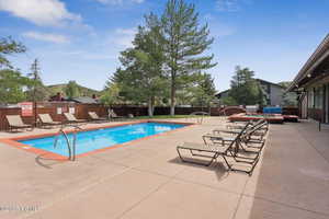 Community pool featuring a patio