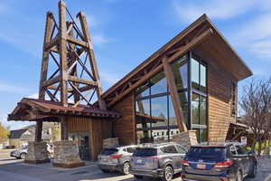 View of building exterior featuring uncovered parking