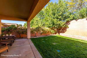 Fenced backyard with a patio area