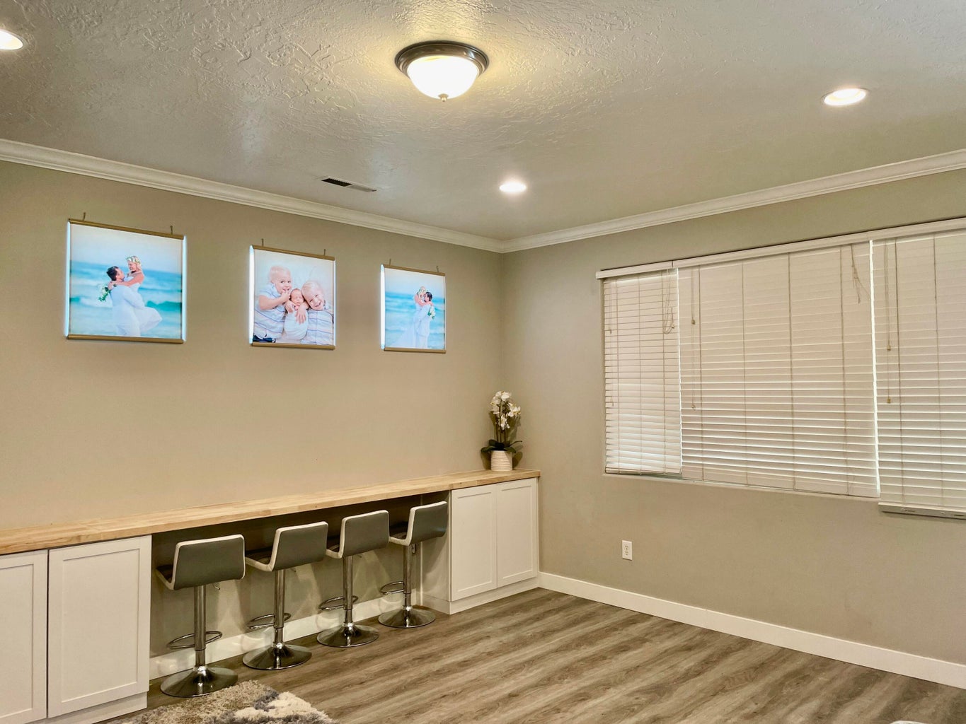 Office space with light wood-style floors, ornamental molding, a textured ceiling, and recessed lighting