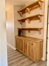 Detailed view of wood finished floors and baseboards