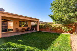 Fenced backyard featuring a patio