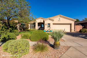 Mediterranean / spanish house featuring a garage, driveway, and stucco siding