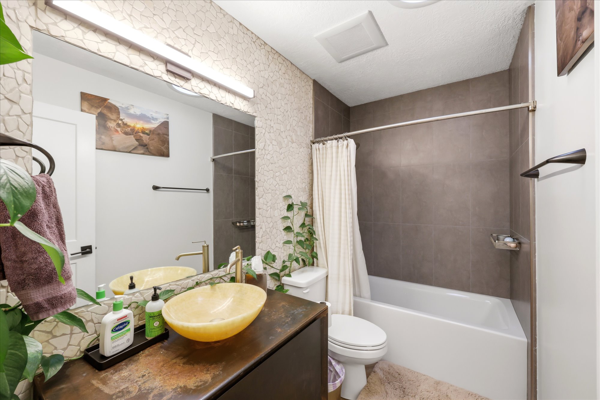 Bathroom featuring vanity and shower / bath combo with shower curtain