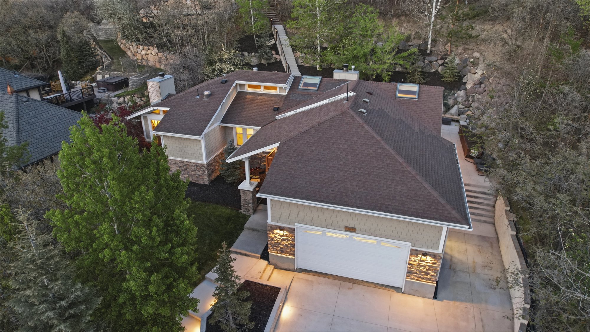 View of subject property featuring a tree filled landscape