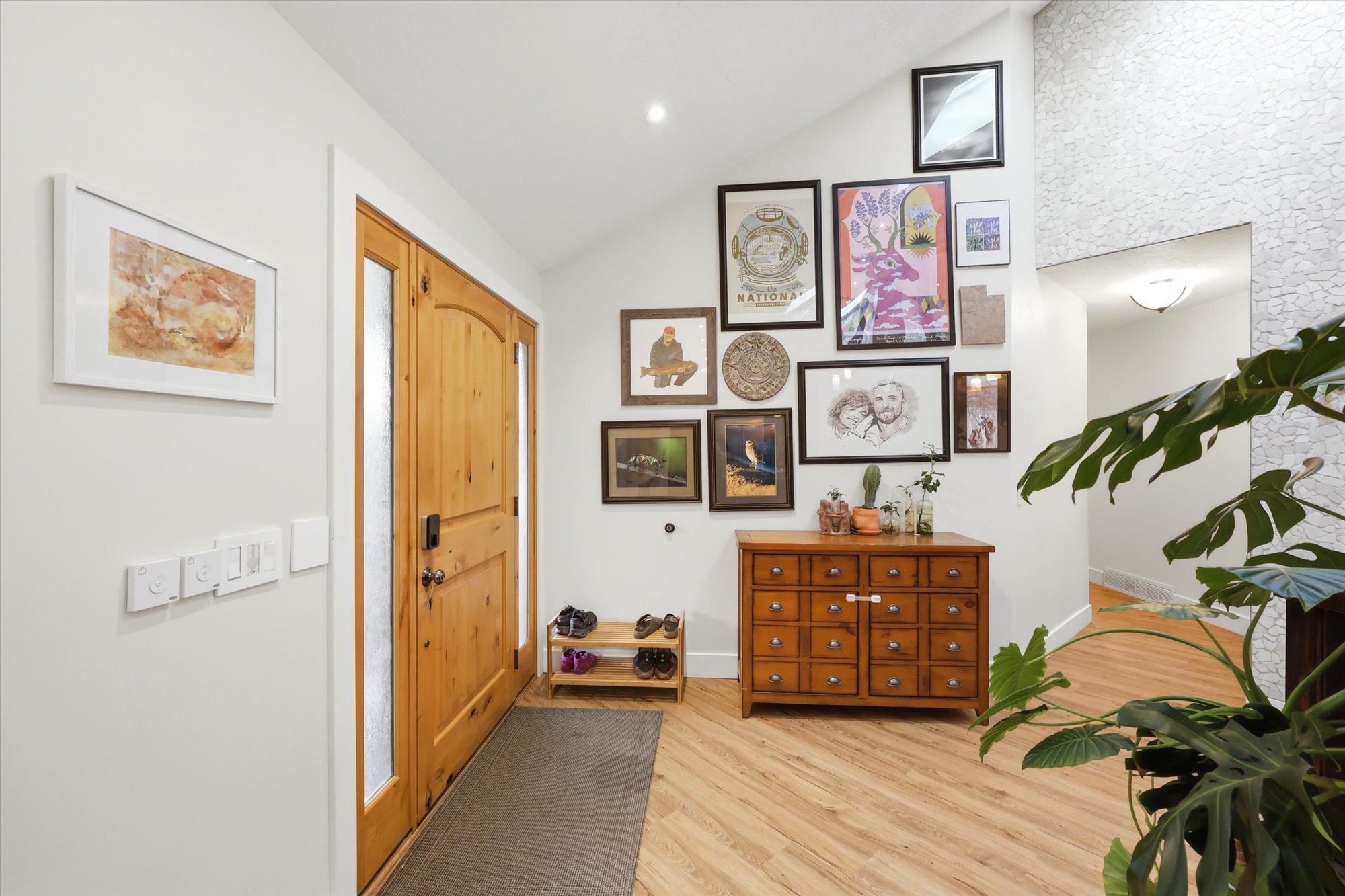 Entrance foyer featuring vaulted ceiling, light wood-style floors, and recessed lighting