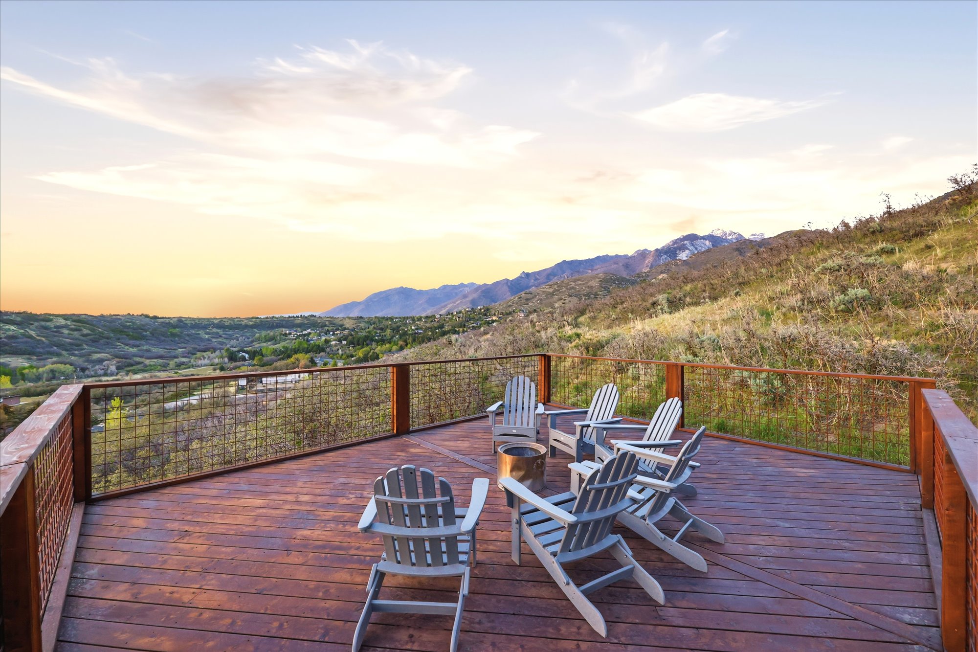 Deck at dusk featuring an outdoor fire pit and a mountain view