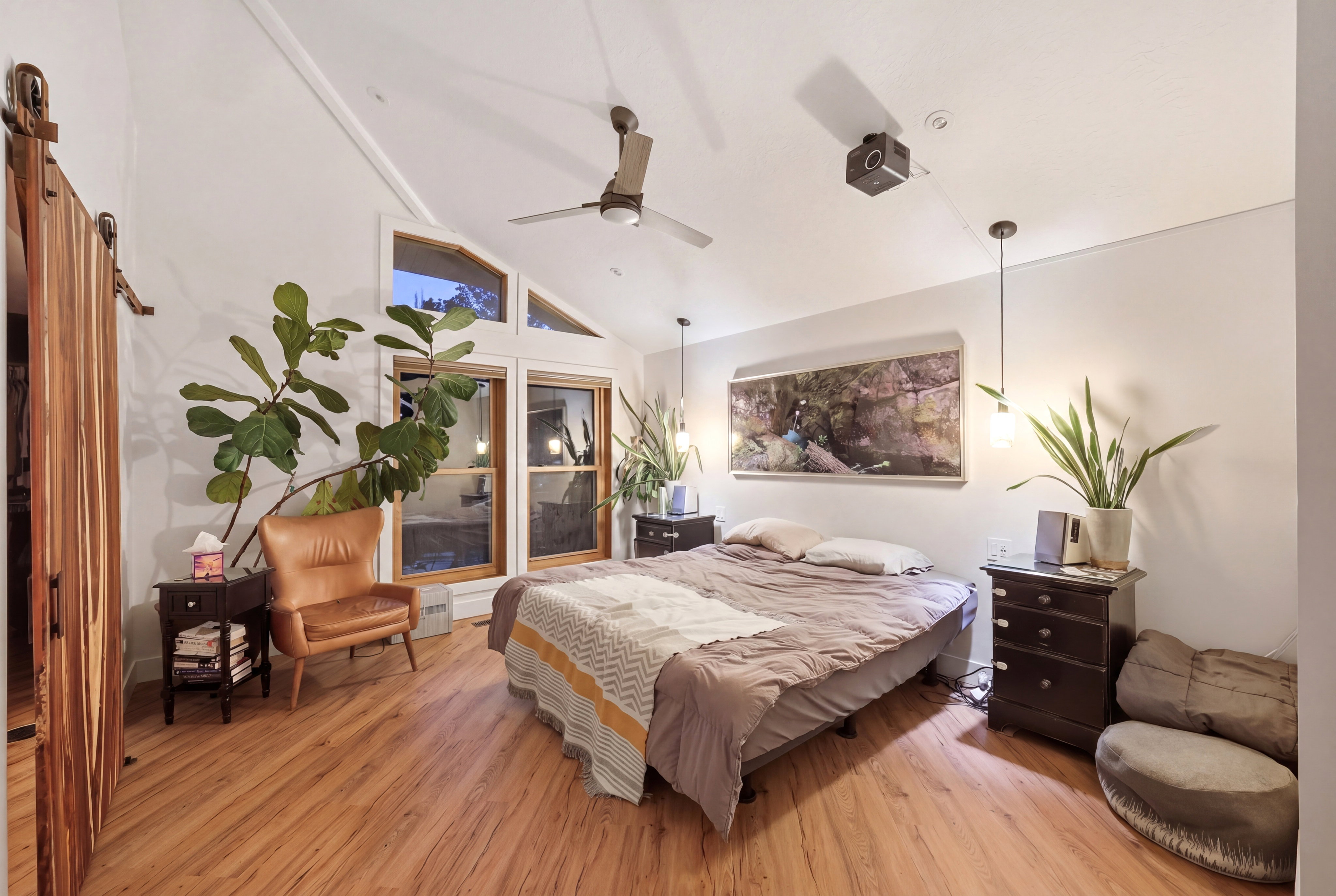 Bedroom with light wood-style flooring and lofted ceiling