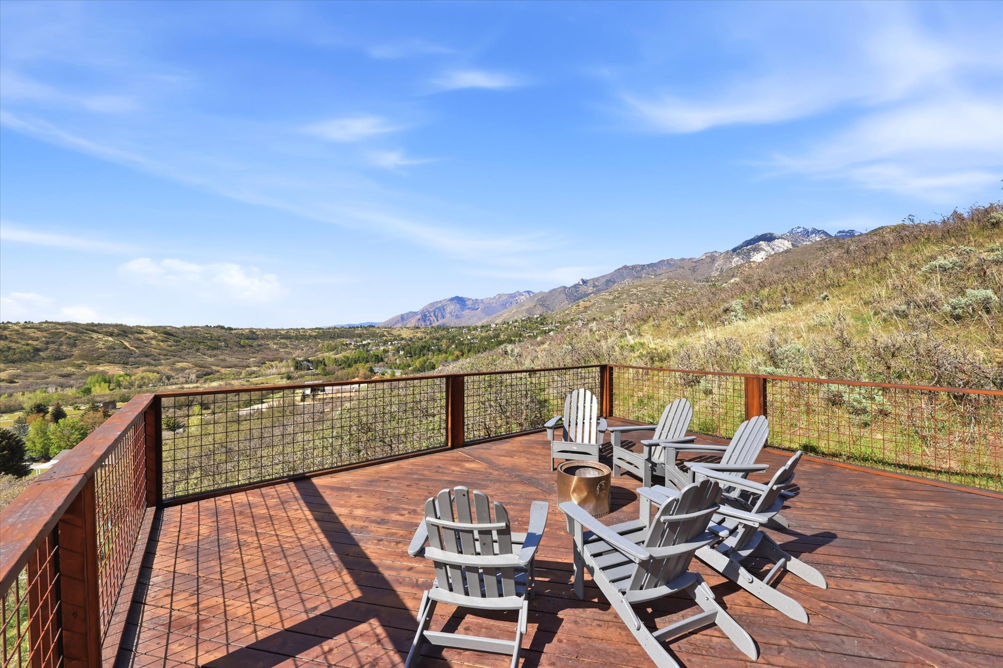 Wooden terrace featuring a mountain view and a fire pit