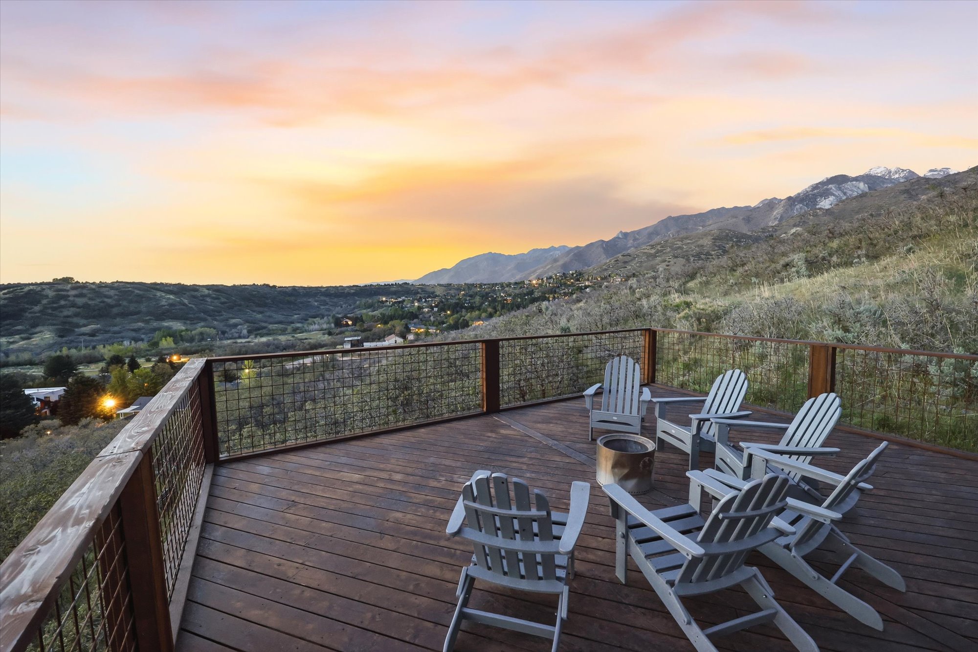 Deck at dusk featuring a mountain view