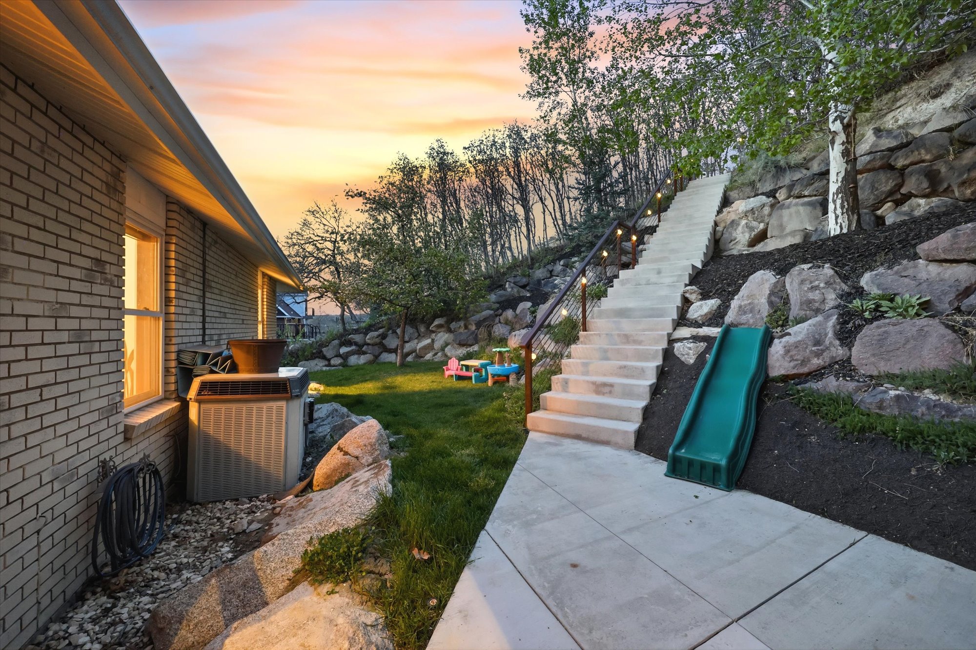 Yard at dusk featuring stairs and a yard
