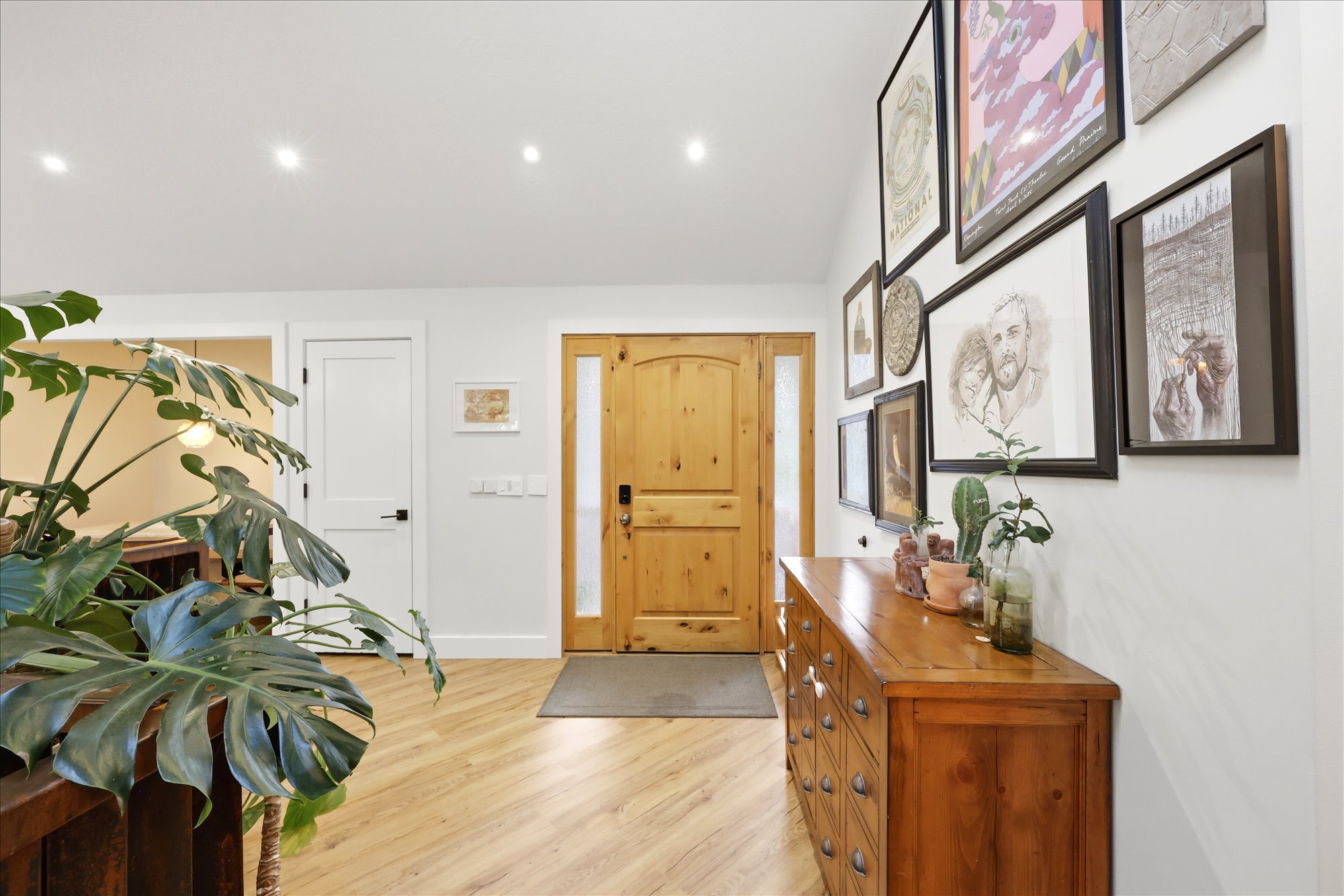 Entrance foyer featuring light wood finished floors, lofted ceiling, and recessed lighting