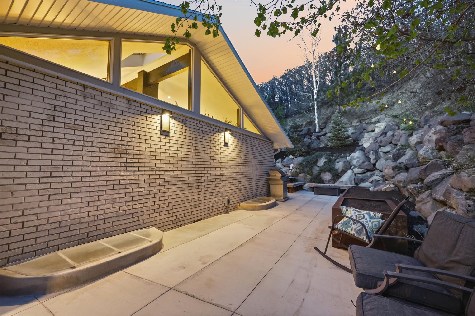 Property exterior at dusk featuring brick siding and a patio