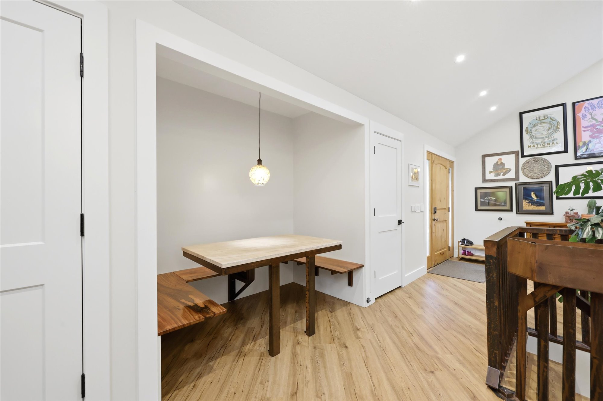 Dining room featuring light wood-type flooring, vaulted ceiling, and recessed lighting