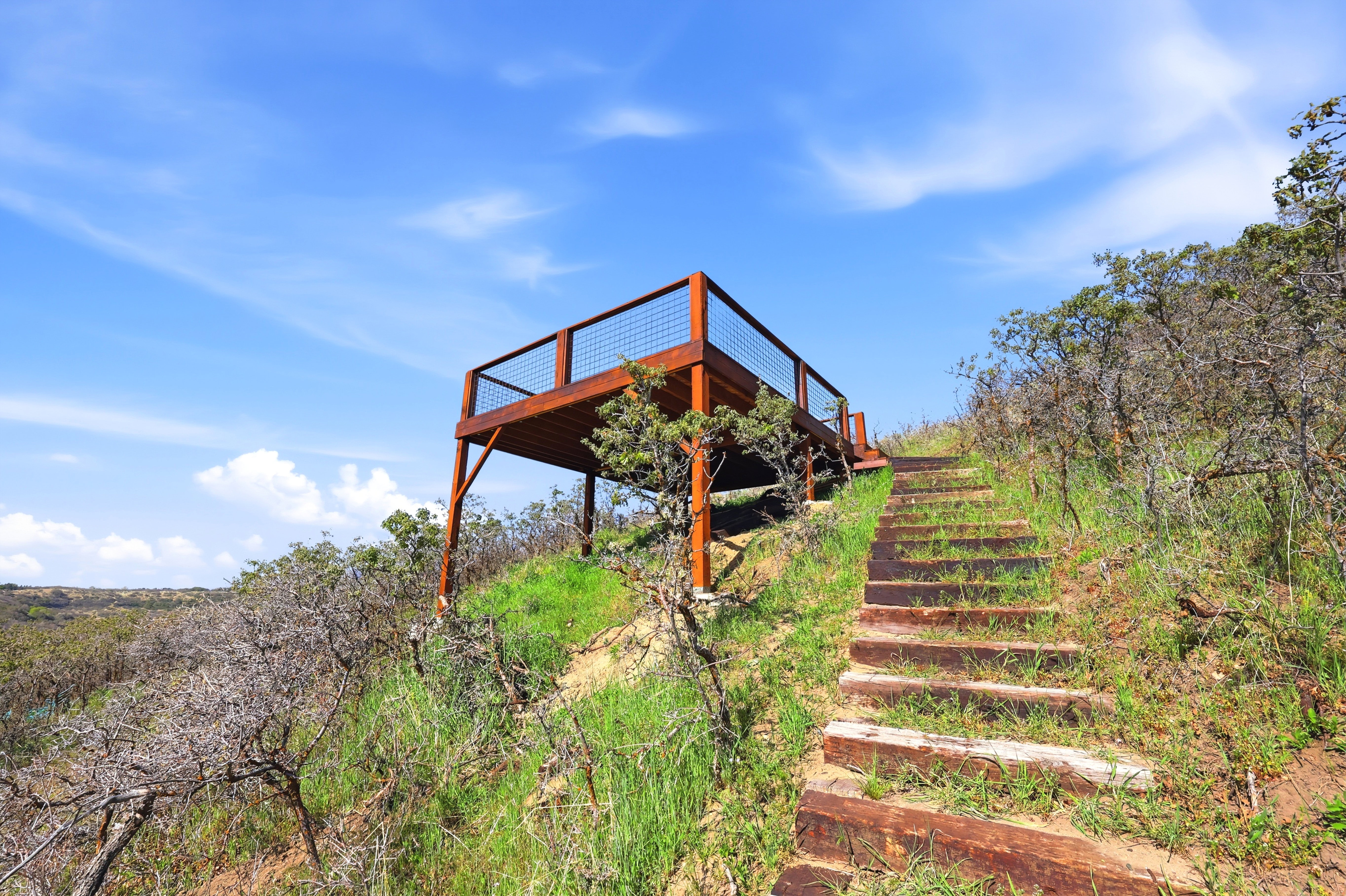 View of property's community featuring stairway and a deck