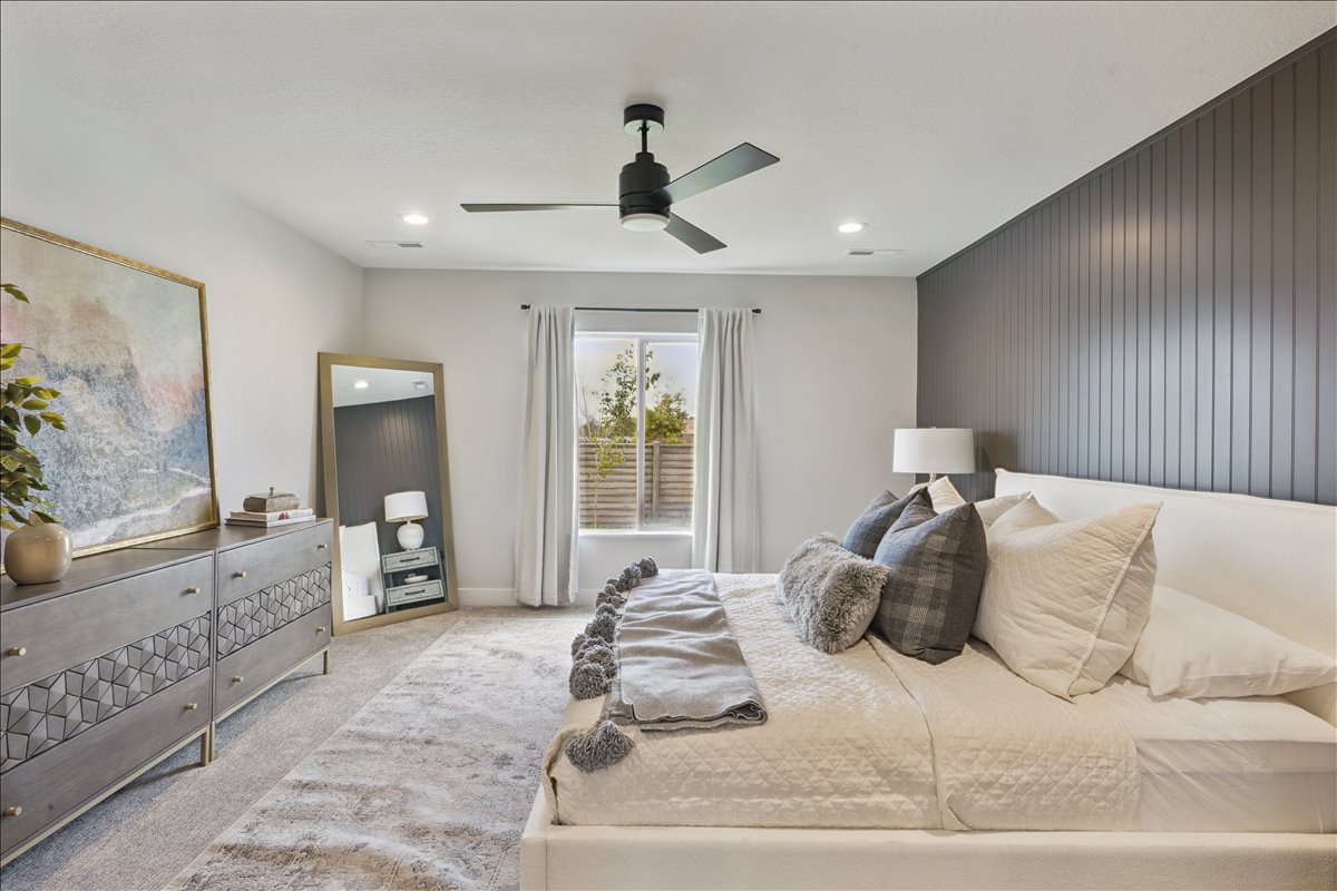Bedroom featuring light colored carpet, a ceiling fan, an accent wall, recessed lighting, and wood walls